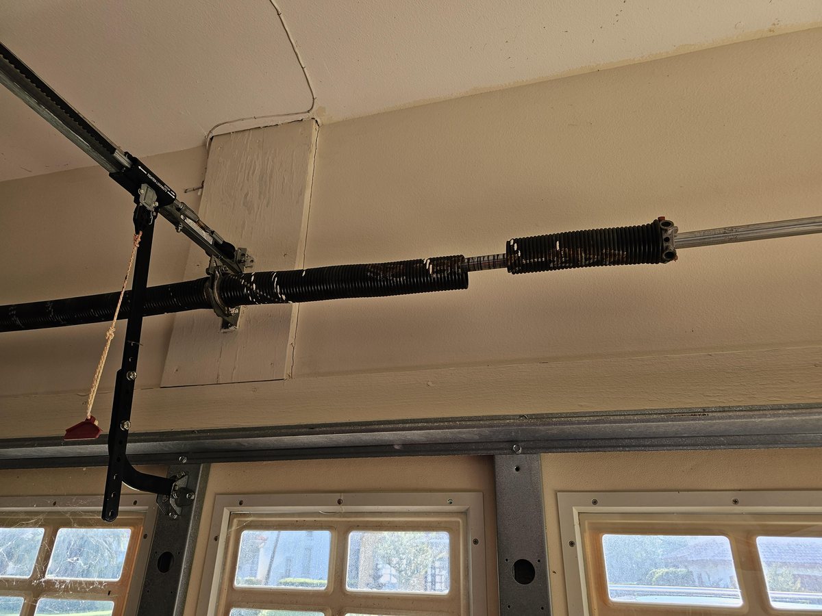Close-up of a broken garage door torsion spring