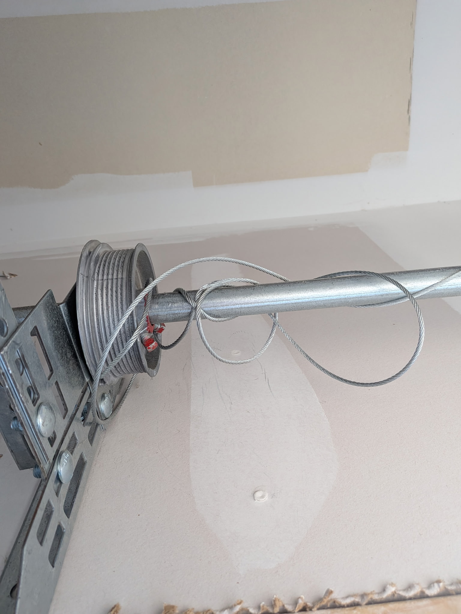 Garage door cable drum and cable repair close-up