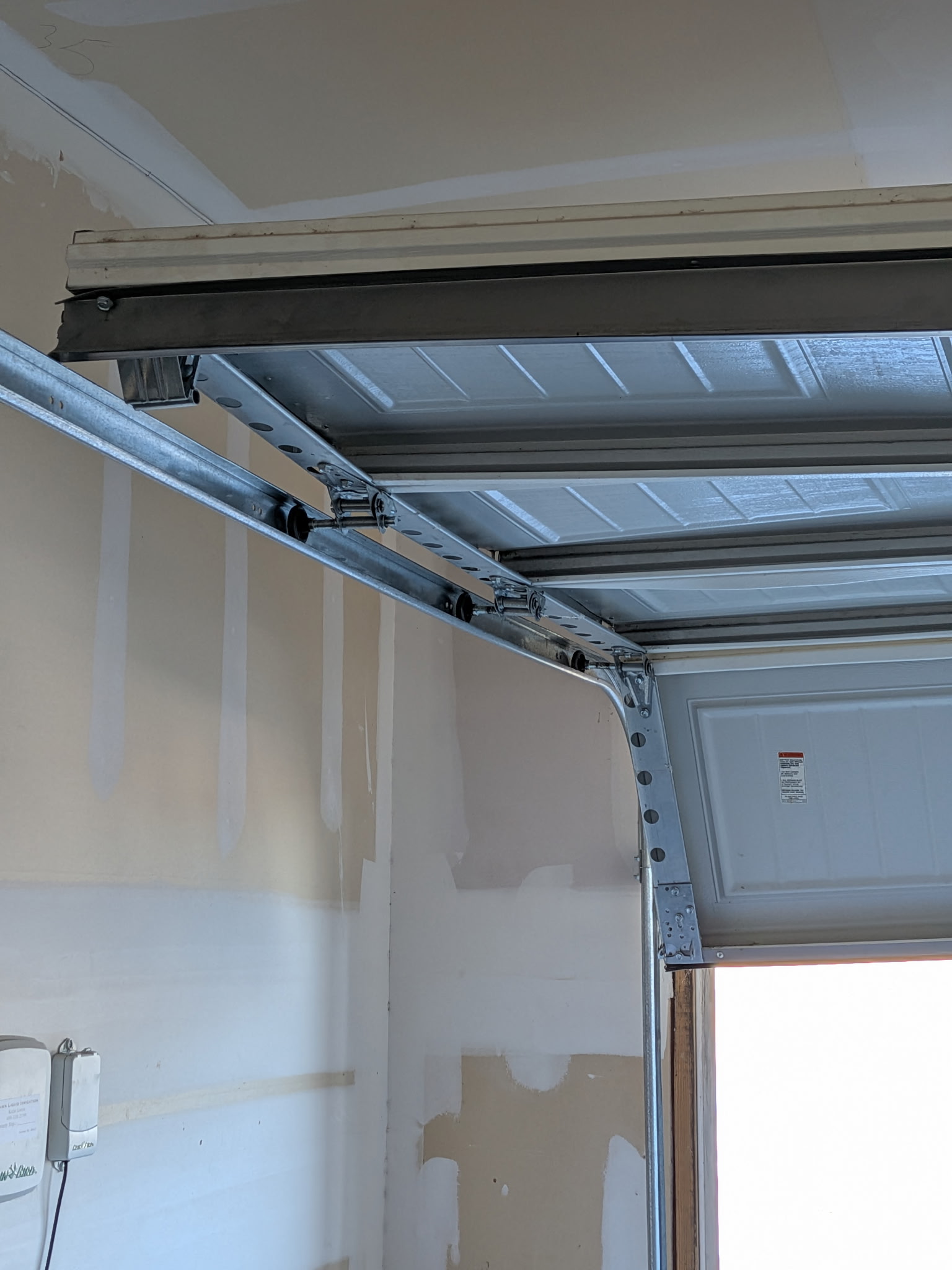 Garage door rollers and track hardware inside a garage