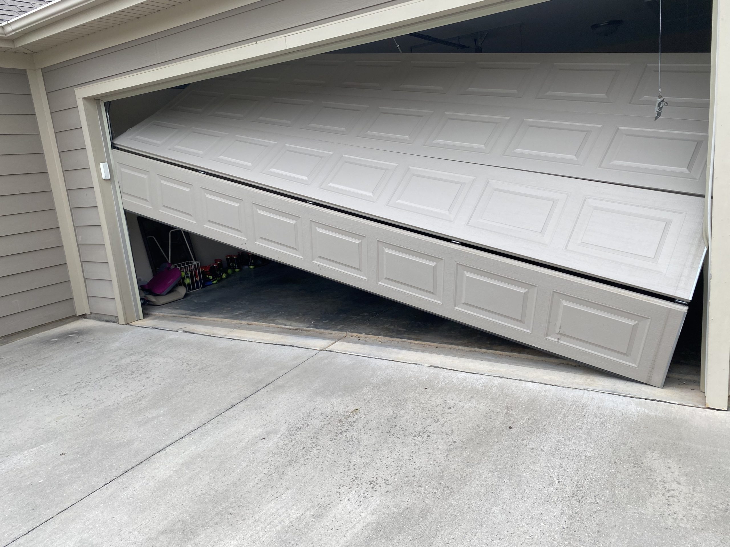 Garage door off track and stuck at an angle