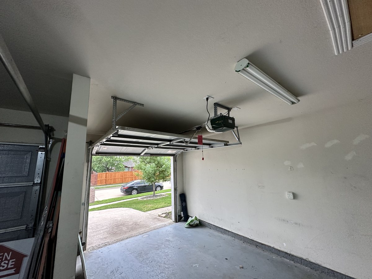 Garage door opener and overhead rail inside a garage